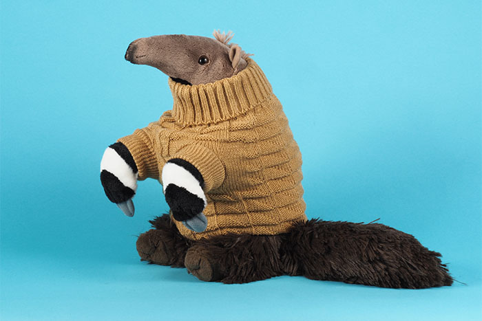 Image of a plush anteater wearing a beige turtleneck sweater