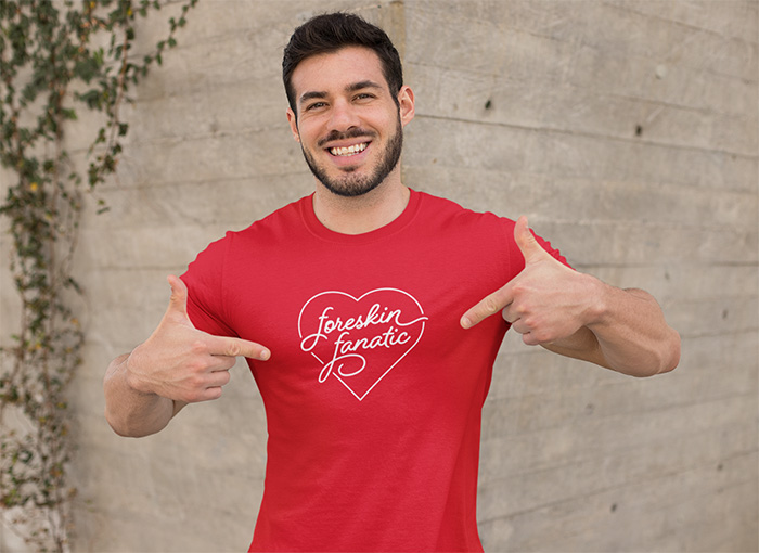 Man pointing to his shirt that says 'foreskin fanatic' in a heart